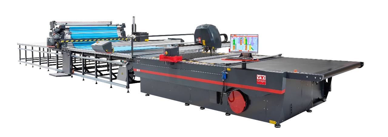 Studio photograph of a CNC automated fabric cutter with fabric spreader and cutting table